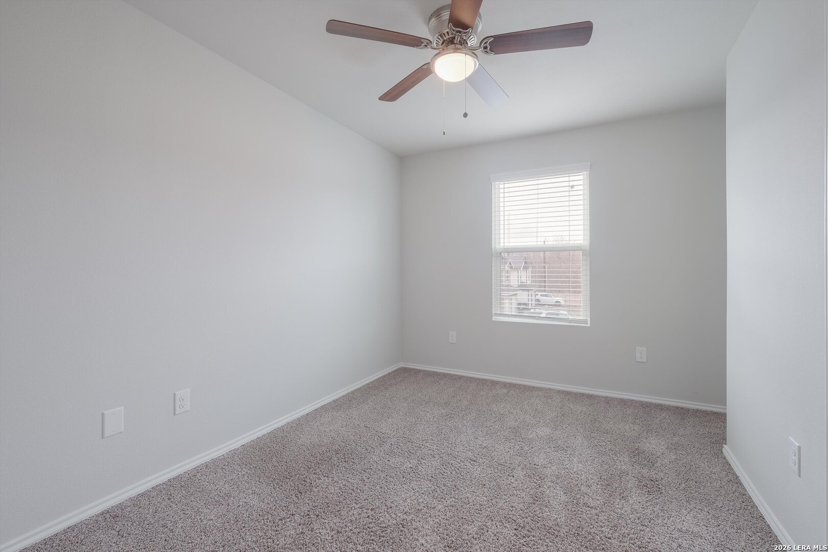 7356 Misty Ridge Drive, Unit 101 Converse, TX 78109 - Photo 9 of 18 an empty room with a window and a fan