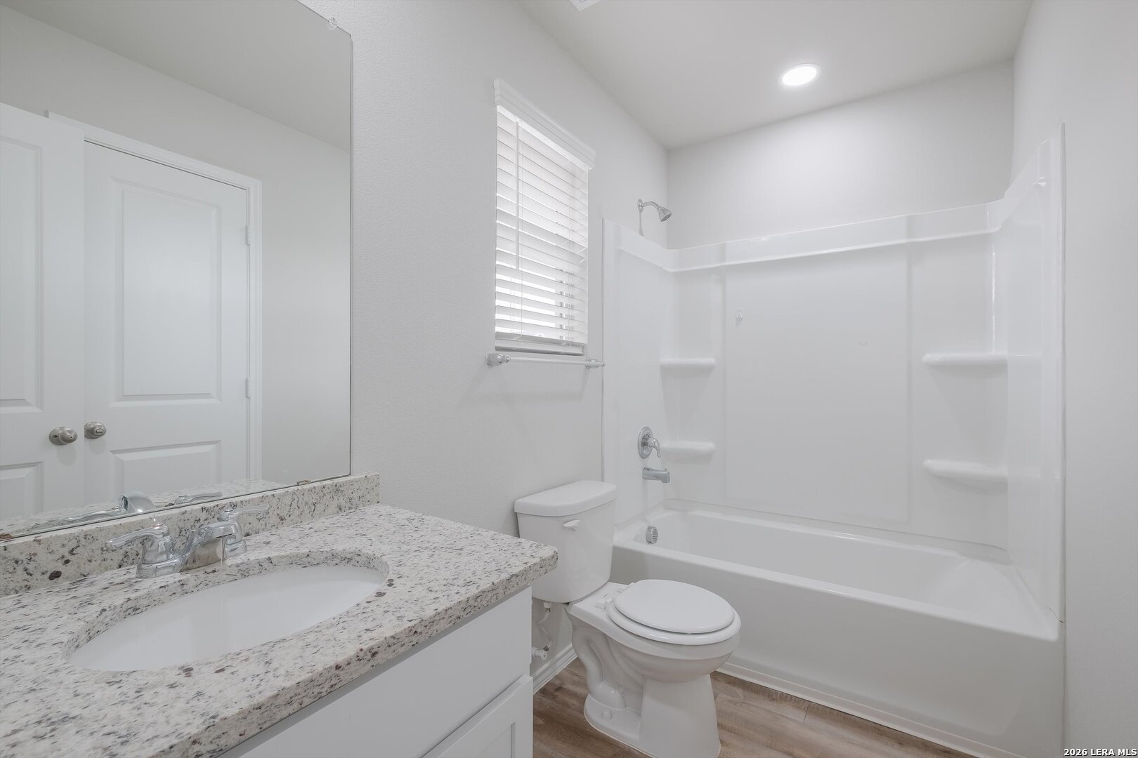 7356 Misty Ridge Drive, Unit 101 Converse, TX 78109 - Photo 10 of 18 a bathroom with a granite countertop sink toilet and shower