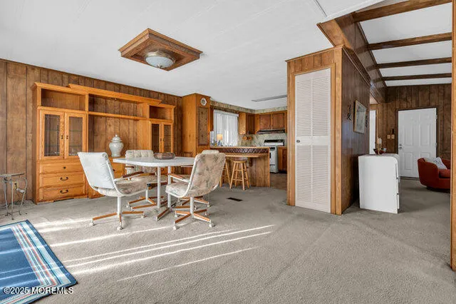 a view of a dining room with furniture a chandelier and wooden floor