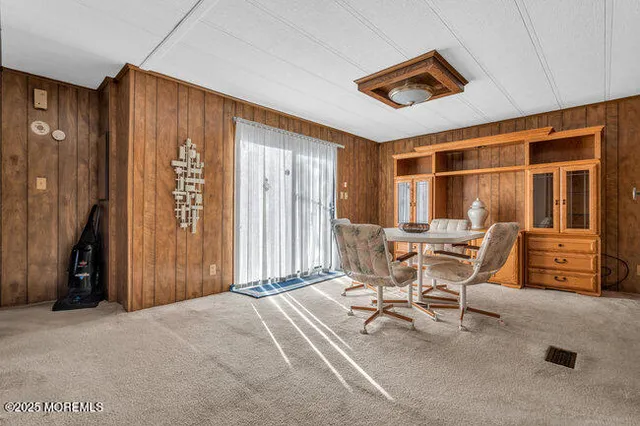 a dining room with furniture and a window