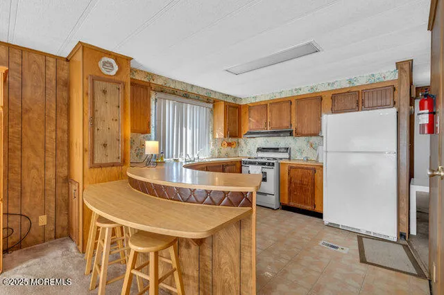 a kitchen with a refrigerator a stove a sink and a dishwasher