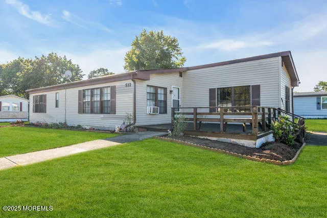 a view of a house with backyard and sitting area