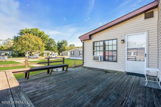 a view of a house with wooden floor and outdoor seating