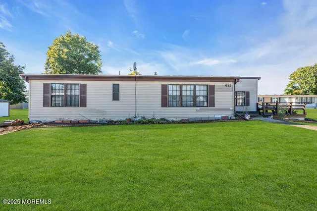 a front view of house with yard and outdoor seating