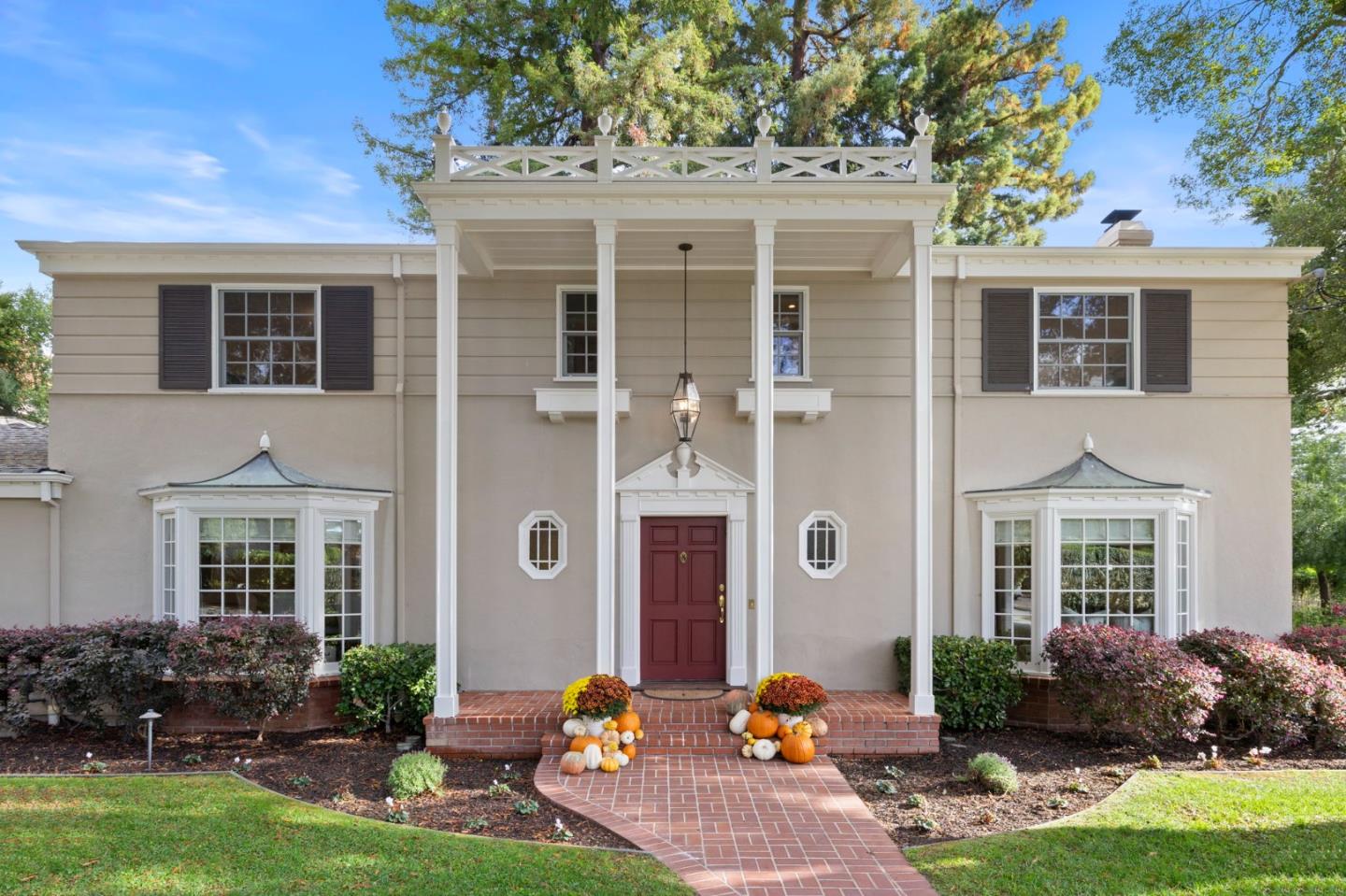 a front view of a house with yard porch and outdoor seating
