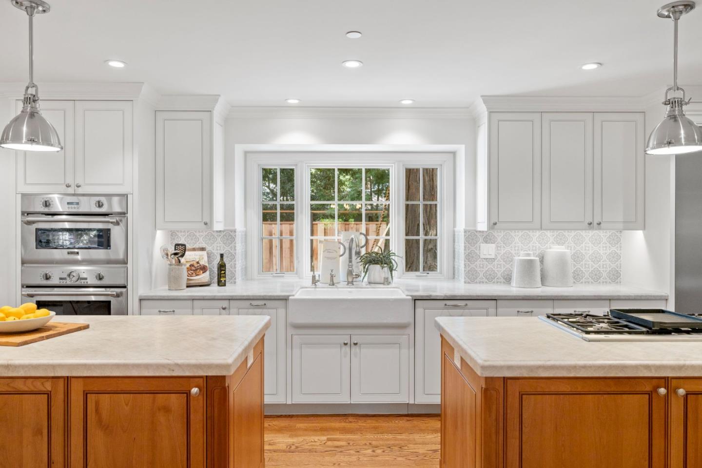 310 Ranelagh Road Hillsborough, CA 94010 - Photo 14 of 51 a kitchen with a sink stove and cabinets