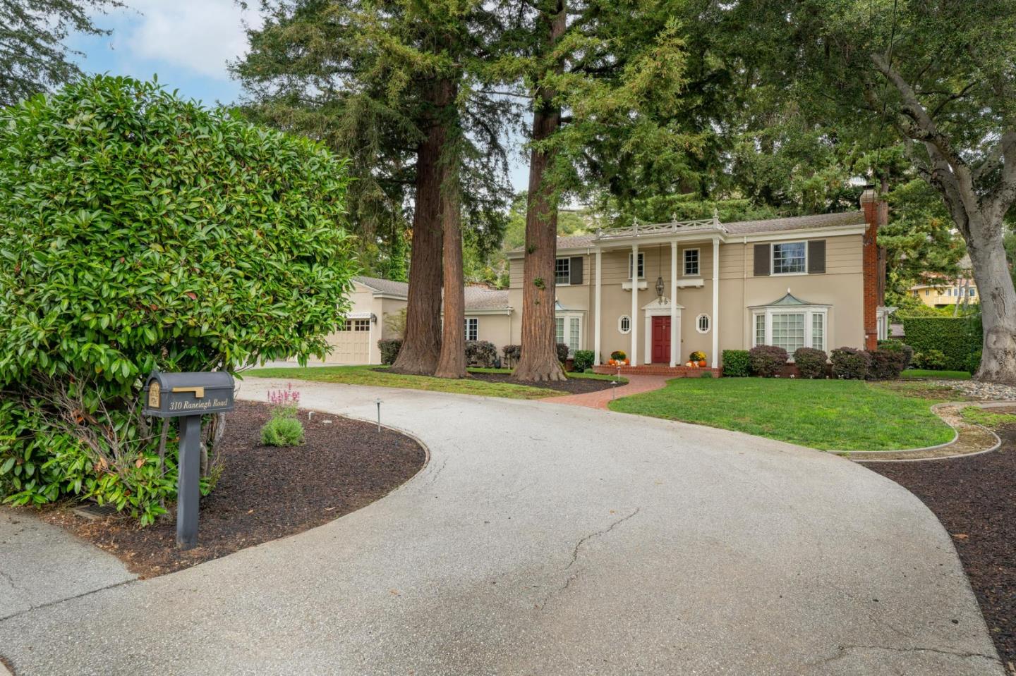 310 Ranelagh Road Hillsborough, CA 94010 - Photo 2 of 51 a front view of a house with a yard and trees