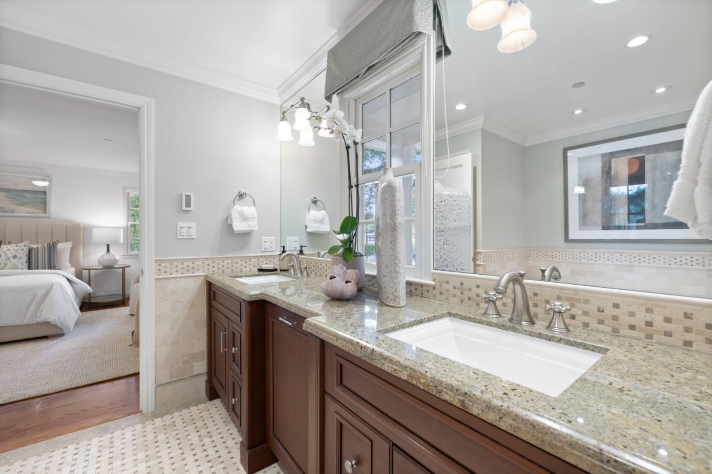 310 Ranelagh Road Hillsborough, CA 94010 - Photo 27 of 51 a bathroom with a granite countertop sink a large mirror and shower