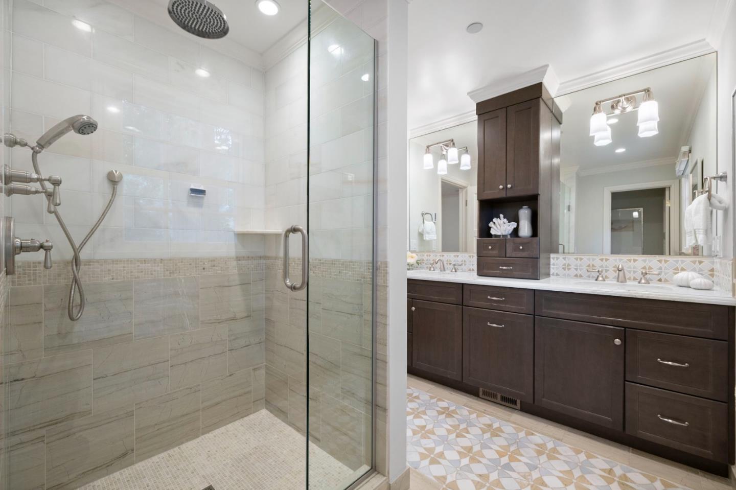310 Ranelagh Road Hillsborough, CA 94010 - Photo 35 of 51 a bathroom with a sink a light fixture and a glass door shower
