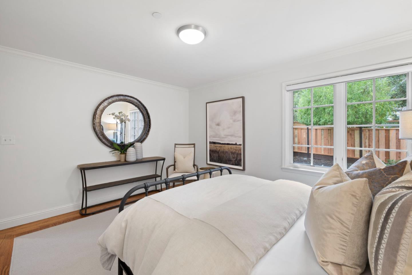 310 Ranelagh Road Hillsborough, CA 94010 - Photo 39 of 51 a bedroom with a bed a mirror and a large window