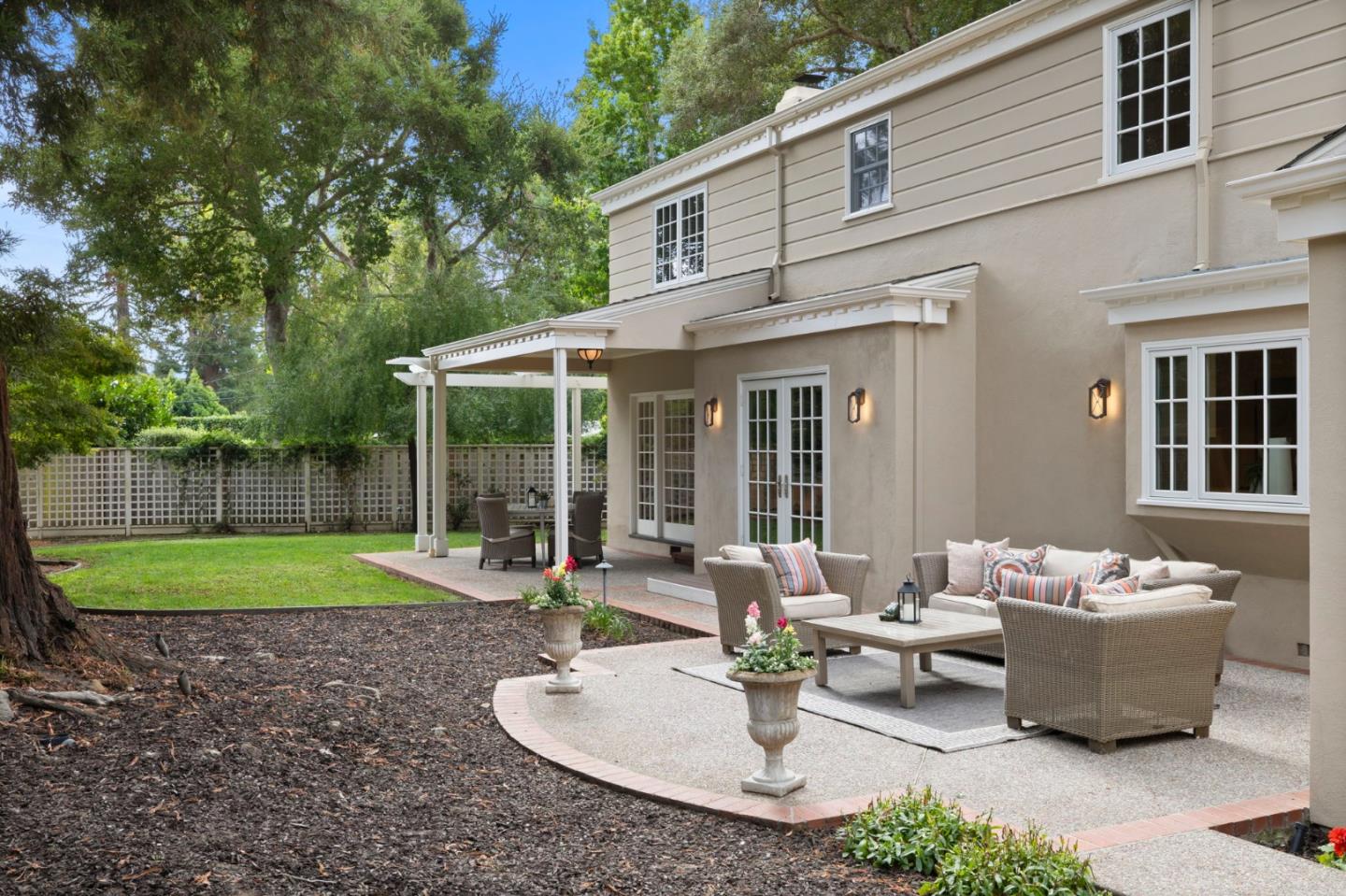 310 Ranelagh Road Hillsborough, CA 94010 - Photo 46 of 51 a view of a patio with couches table and chairs and potted plants
