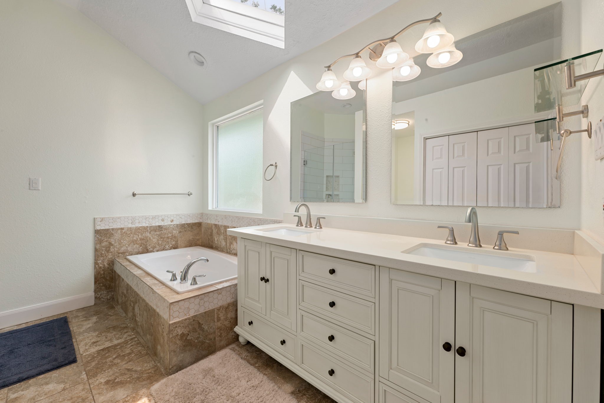 1915 Mercoal Drive Spring, TX 77386 - Photo 18 of 50 Luxurious primary bath with dual vanities, soaking tub, and a separate walk-in shower.