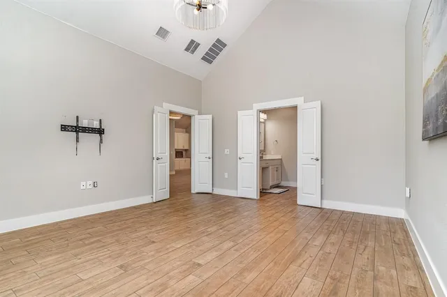 a view of cabinets a wooden floor and a window