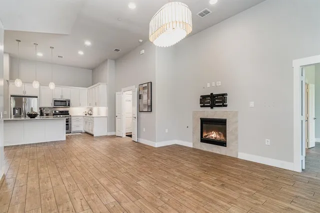 a view of kitchen with kitchen island wooden floor center island and appliances
