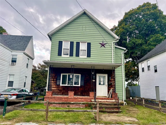 a front view of residential houses with yard and furniture