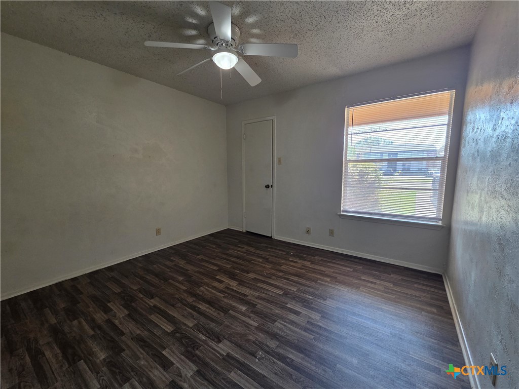 1802 Azalea Drive Temple, TX 76502 - Photo 13 of 21 an empty room with wooden floor cabinet and windows