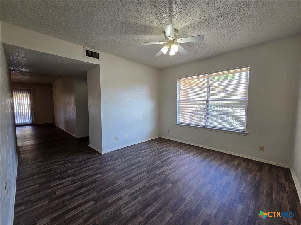 1802 Azalea Drive Temple, TX 76502 - Photo 5 of 21 an empty room with wooden floor chandelier and windows