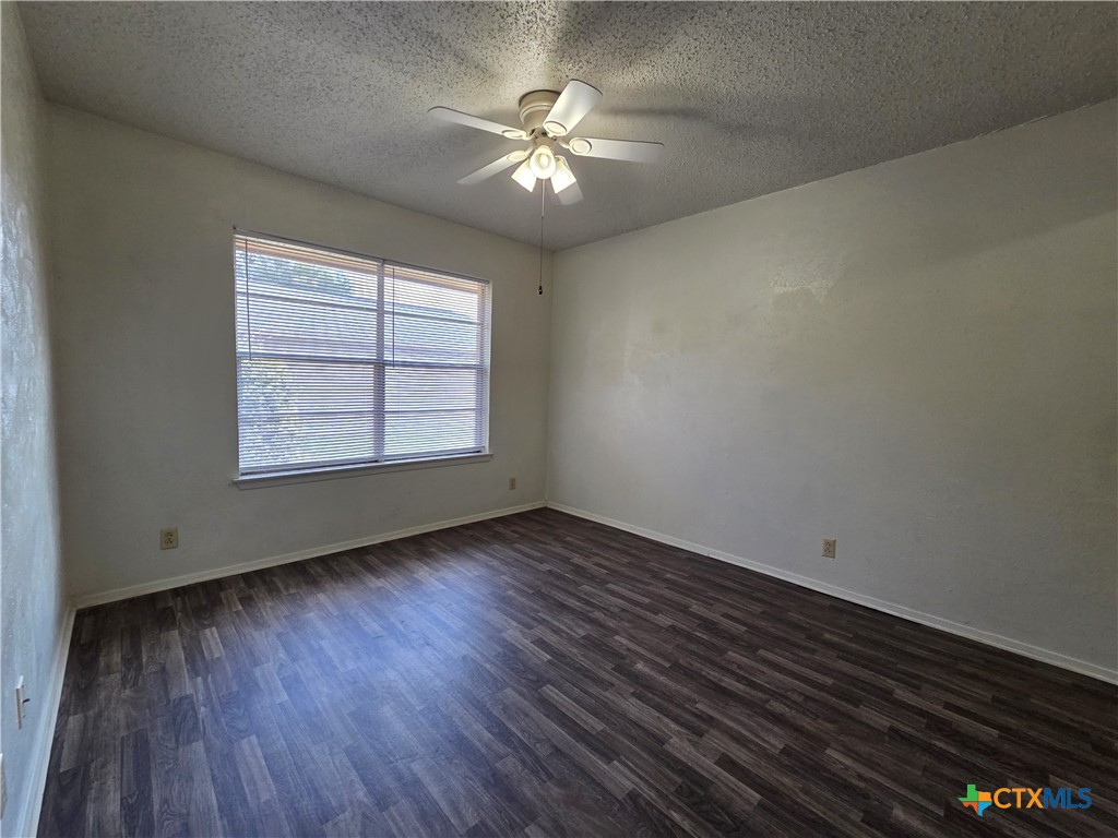 1802 Azalea Drive Temple, TX 76502 - Photo 6 of 21 an empty room with wooden floor and windows