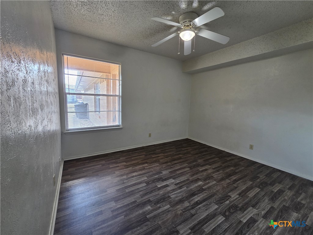 1802 Azalea Drive Temple, TX 76502 - Photo 10 of 21 an empty room with wooden floor fan and windows