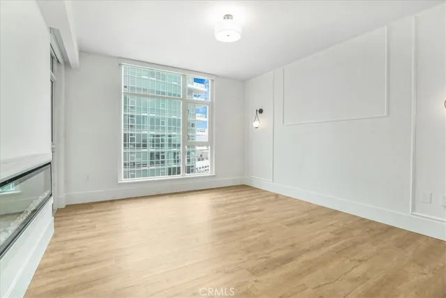 a view of an empty room with wooden floor