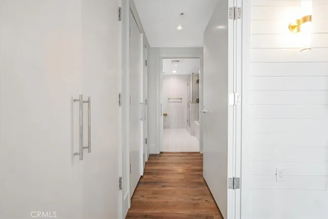 a view of a hallway with wooden floor