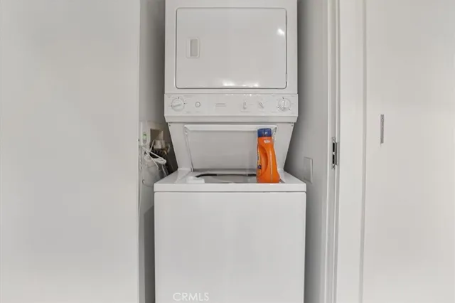 a view of empty room with wooden floor and window