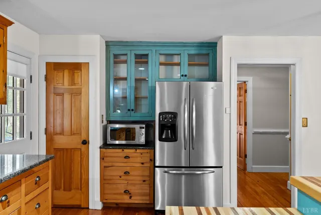 a kitchen with stainless steel appliances granite countertop a stove and a wooden cabinets