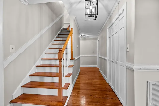 a view of entryway and hall with wooden floor