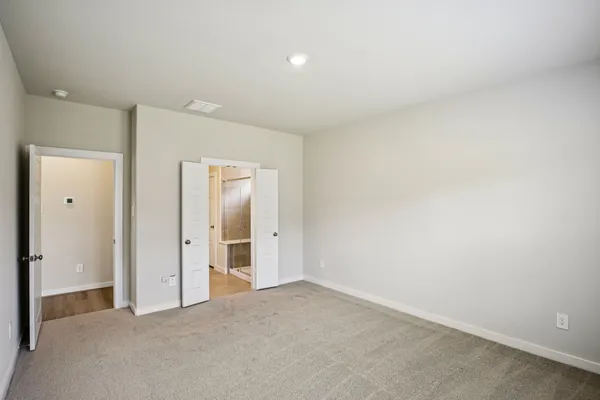 a bedroom with bed and cupboard