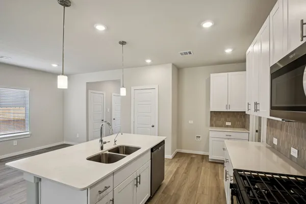 a kitchen with a sink stove and refrigerator