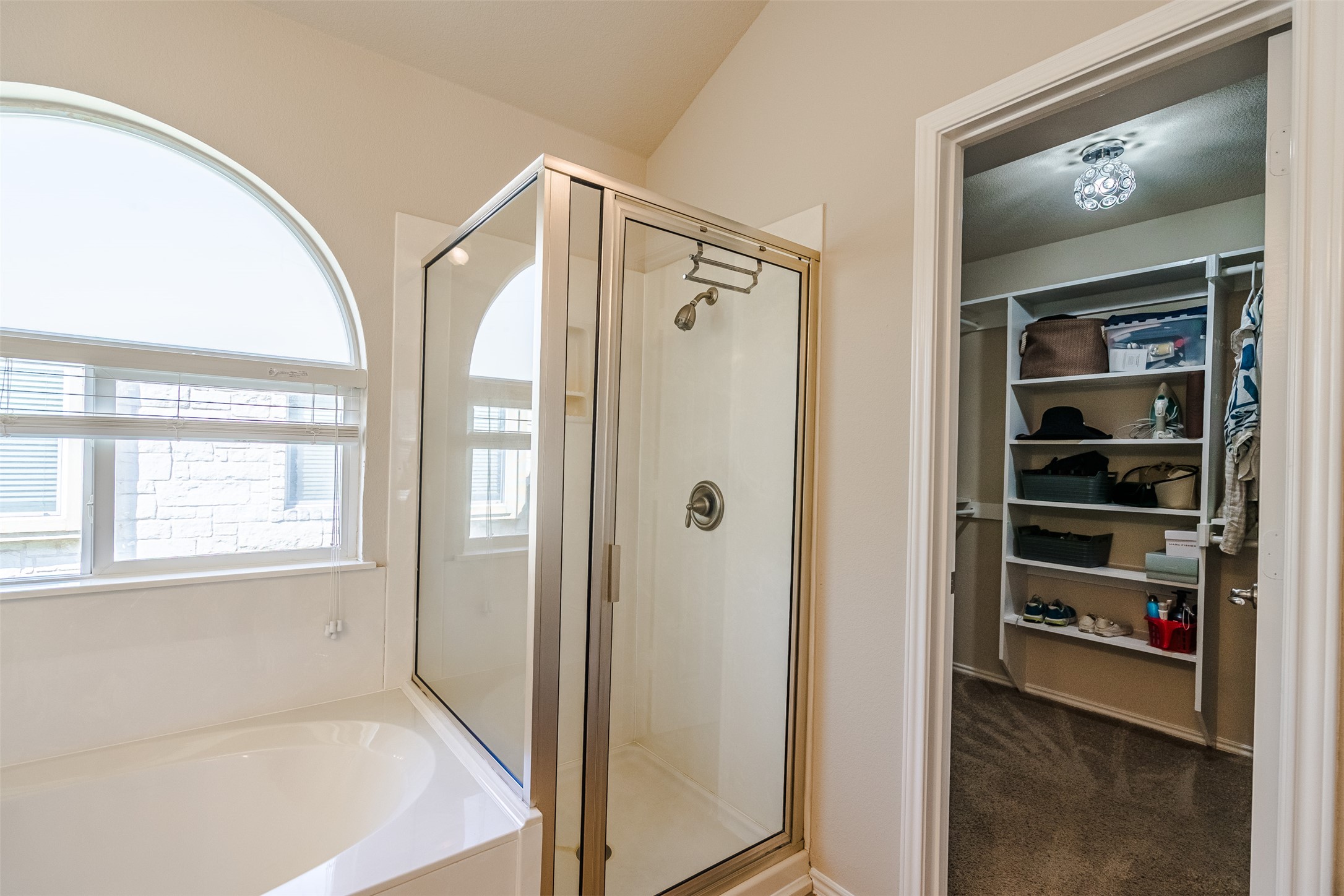 2404 Christoff Loop Austin, TX 78748 - Photo 13 of 24 Full bathroom featuring a shower stall, a spacious closet, and garden tub