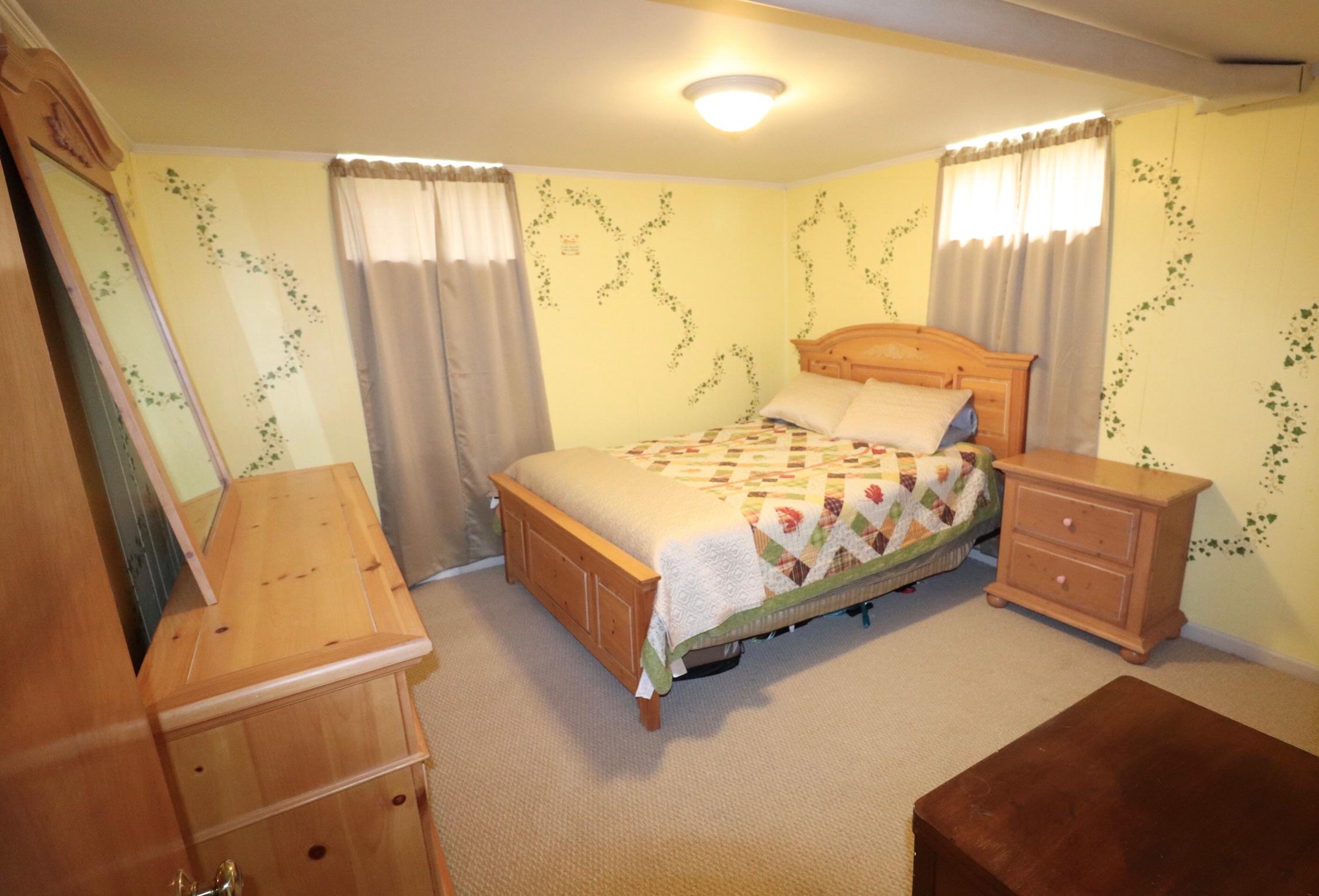 5108 Hazelridge Road Northwest Roanoke, VA 24012 - Photo 18 of 24 a bedroom with a bed and wooden floor