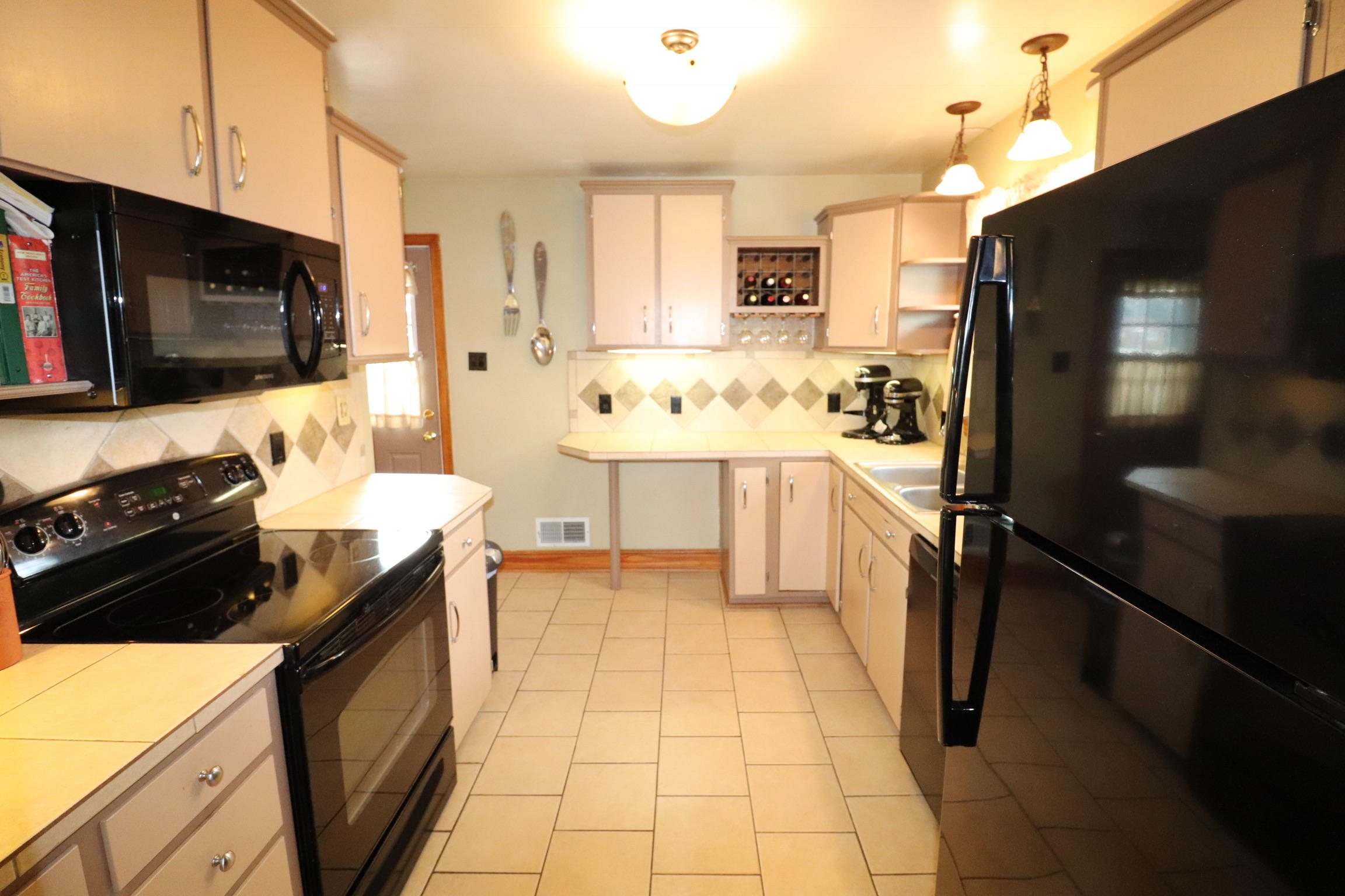 5108 Hazelridge Road Northwest Roanoke, VA 24012 - Photo 7 of 24 a kitchen with a sink stove and refrigerator