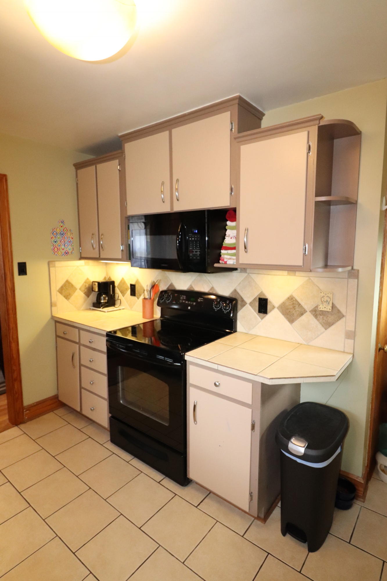 5108 Hazelridge Road Northwest Roanoke, VA 24012 - Photo 9 of 24 a kitchen with a stove a sink and a microwave