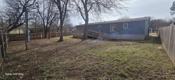 a view of a yard with a tree