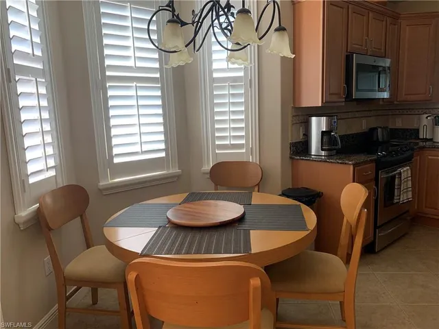 a kitchen with a table chairs and a dining table