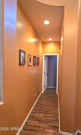 a view of a hallway with wooden floor