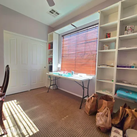 a reading room with furniture and a window