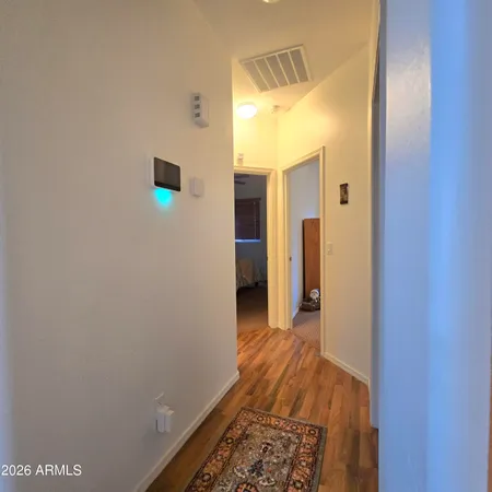 a view of hallway with wooden floor