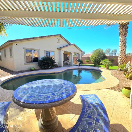 a swimming pool with outdoor seating