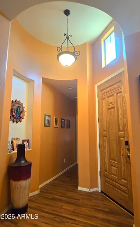 a view of a livingroom with wooden floor and ceiling fan