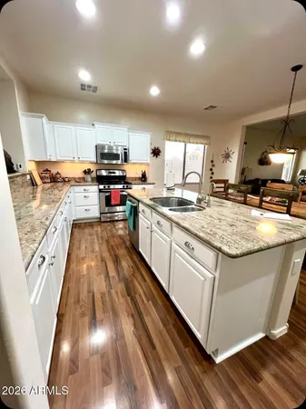 a kitchen with stainless steel appliances granite countertop a stove and a sink