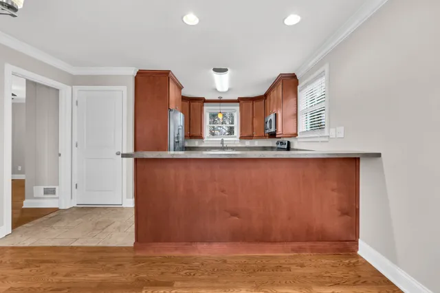 a view of kitchen with cabinets and wooden floor