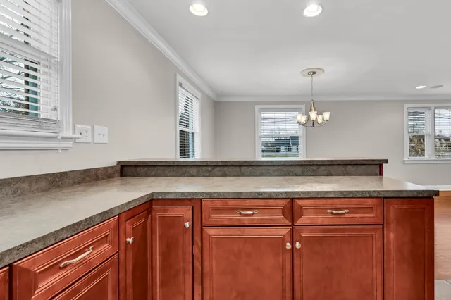 a kitchen with cabinets and window