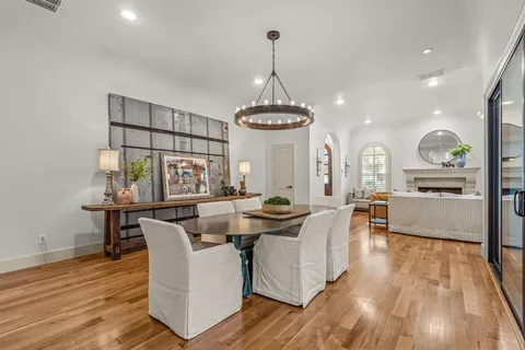 a kitchen with stainless steel appliances granite countertop a stove a sink dishwasher and cabinets with wooden floor