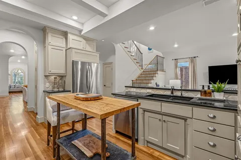 a kitchen with kitchen island granite countertop lots of counter top space and stainless steel appliances
