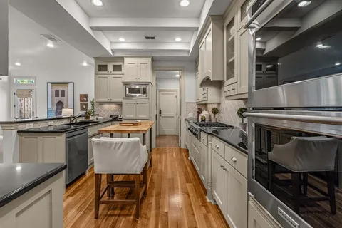 a kitchen with stainless steel appliances a sink and cabinets
