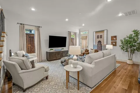 a living room with furniture fireplace and a window