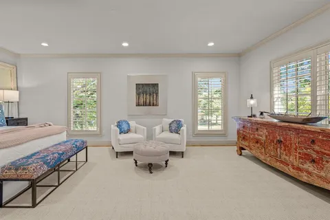 a bedroom with furniture and a large window