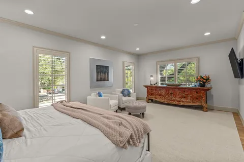 a bedroom with bed and flat screen tv